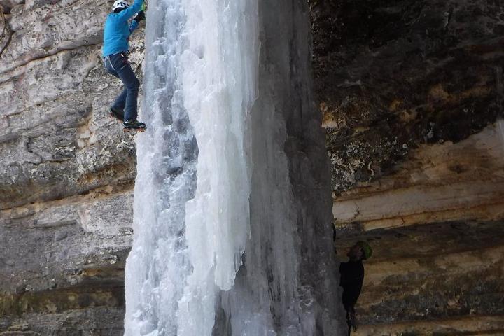 An ice climber on a frozen waterfall in Pictured Rocks National Lakeshore