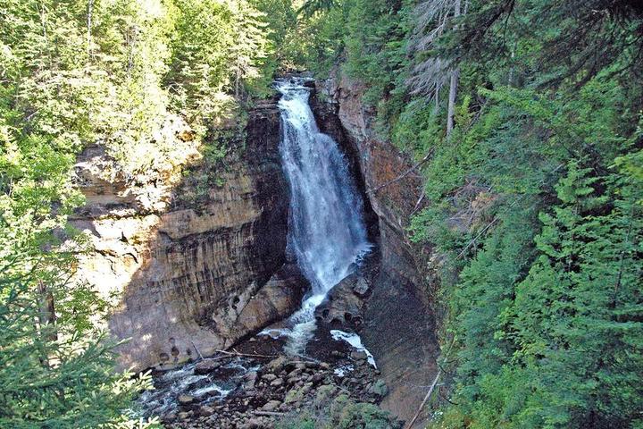 Miners Falls pouring over a sandstone cliff