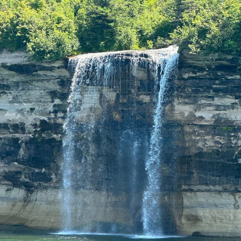 Waterfall pouring over sandstone cliffs