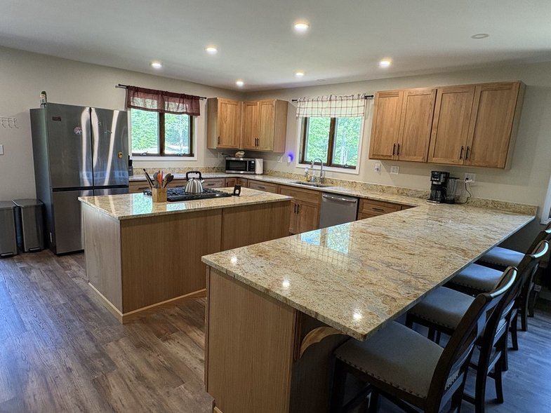 Kitchen with granite counters, island and peninsula seating