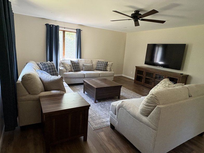 Main-floor living room with sofas and TV
